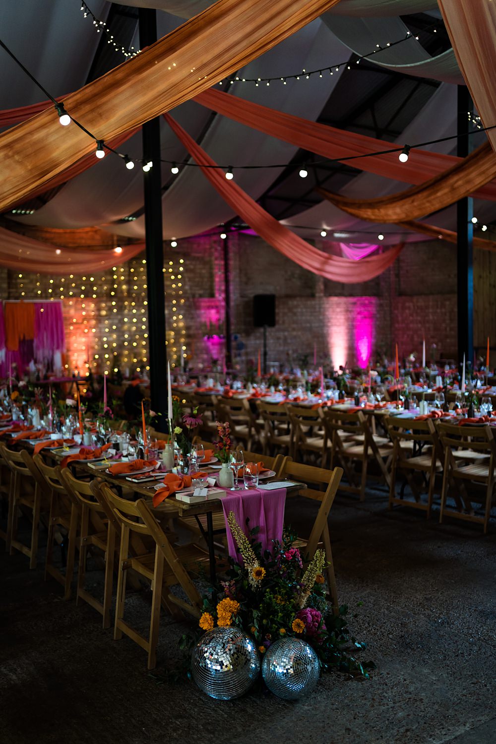 Pink Orange Disco Wedding Lisa and Neil Wedding Photography Fabric Drapes Barn Decor Festoon Lights