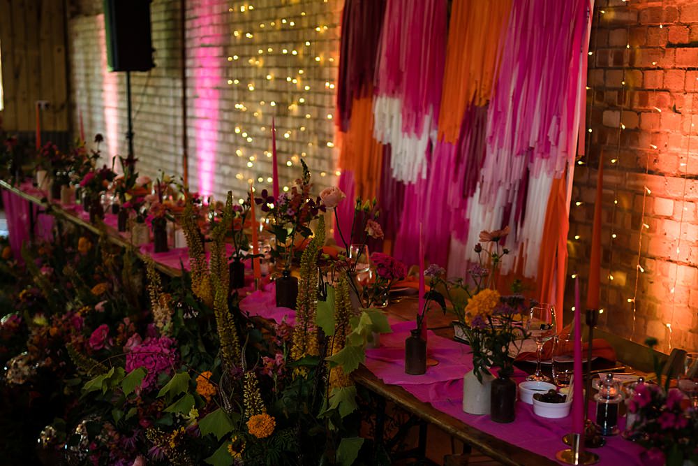 Pink Orange Disco Wedding Lisa and Neil Wedding Photography Streamer Top Table Backdrop