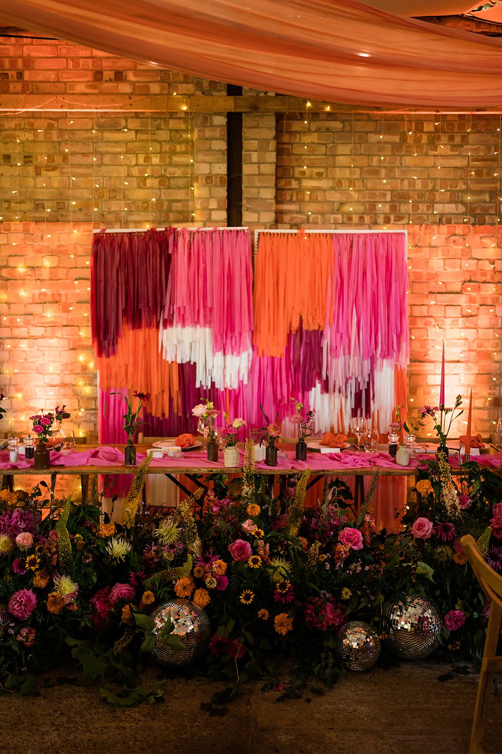 Pink Orange Disco Wedding Lisa and Neil Wedding Photography Streamer Top Table Backdrop Floor Flowers