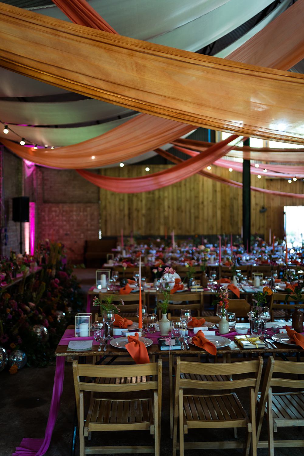 Pink Orange Disco Wedding Lisa and Neil Wedding Photography Fabric Drapes Barn Decor Festoon Lights