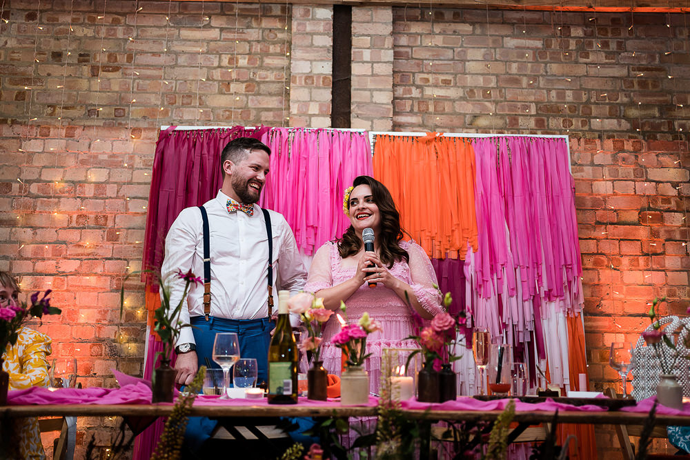 Pink Orange Disco Wedding Lisa and Neil Wedding Photography Streamer Top Table Backdrop