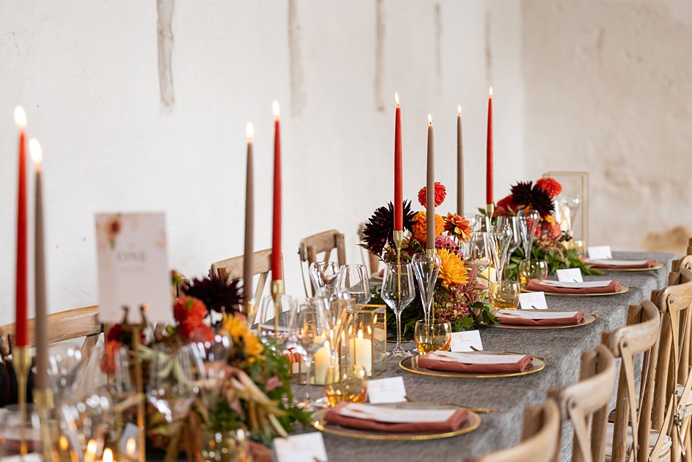 The Courtyard Venue Wedding Ideas Nicki Jones Photography Long Table Grey Cloths Orange Red Candles Flowers Autumn Decor