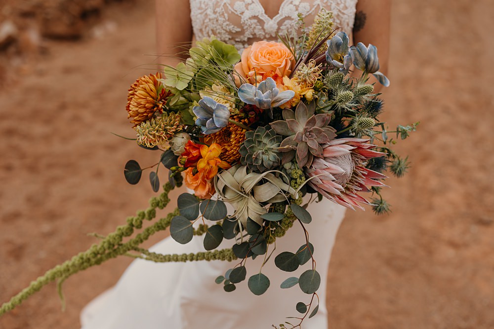 The Red Earth Venue Wedding Adventure and Vow Bouquet Flowers Bride Green Orange