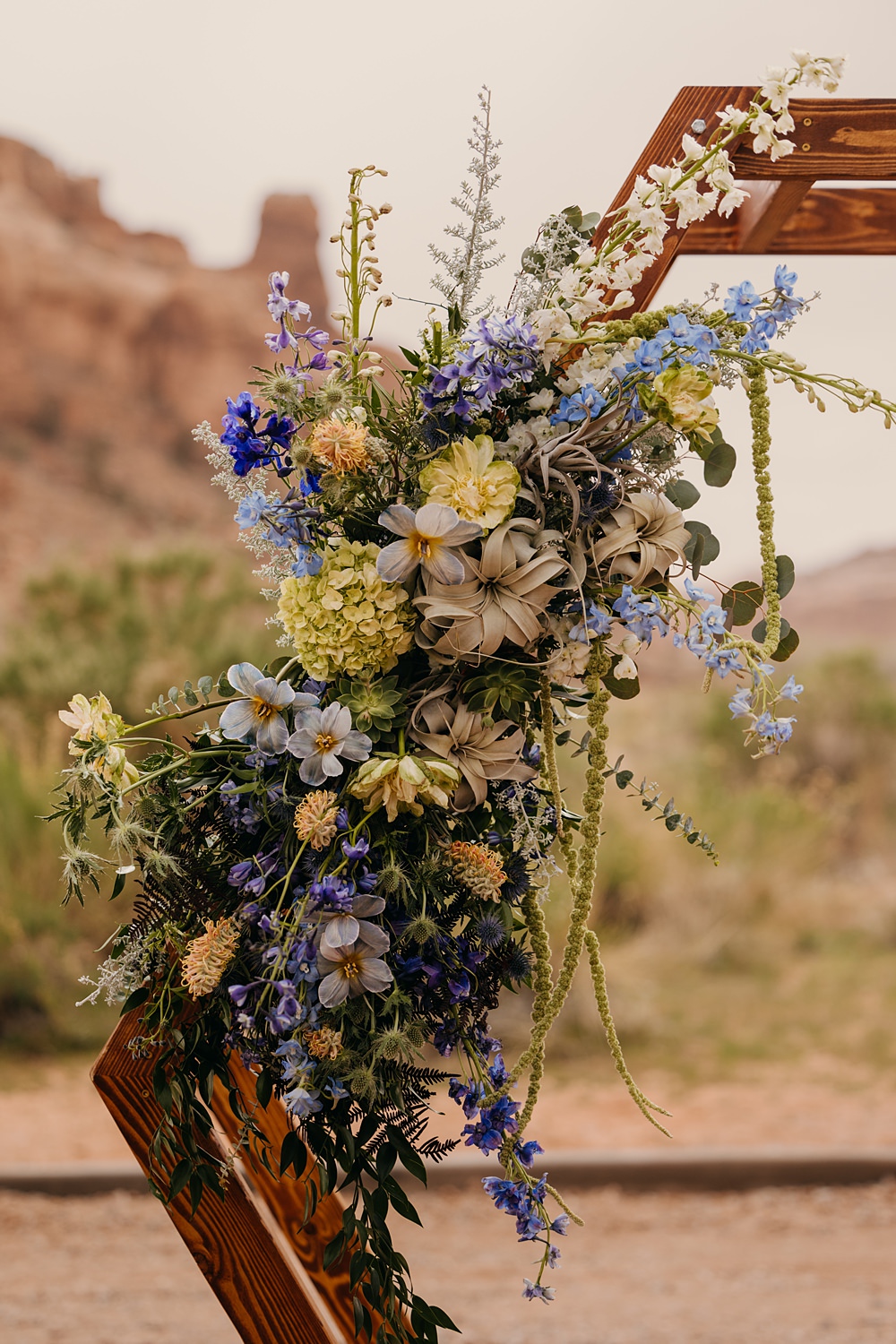 The Red Earth Venue Wedding Adventure and Vow Hexagon Wooden Flower Arch Ceremony Blue