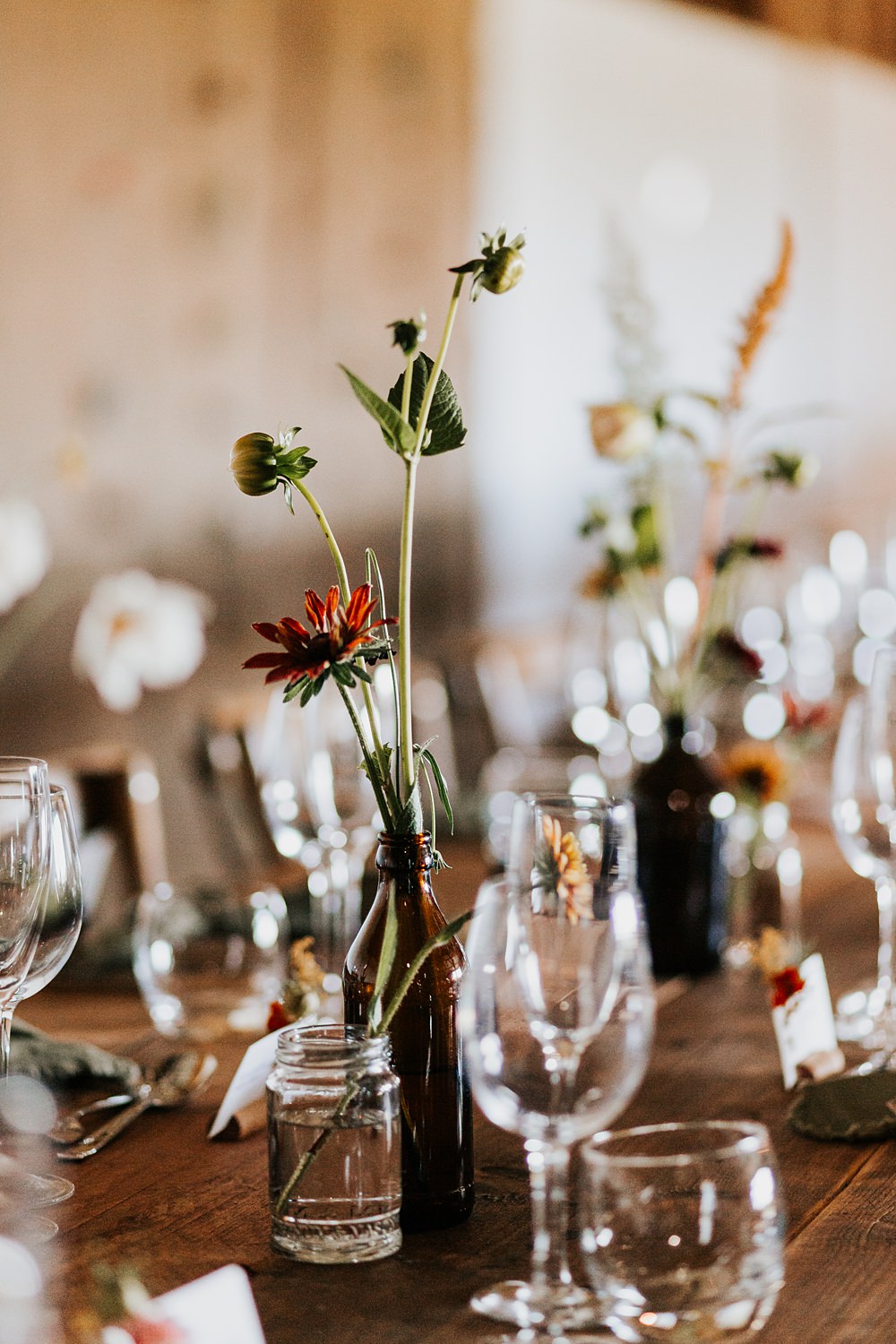 Chidham Barn Wedding Lucy Davis Photography Rustic Wooden Table Flowers Bottles Centrepiece