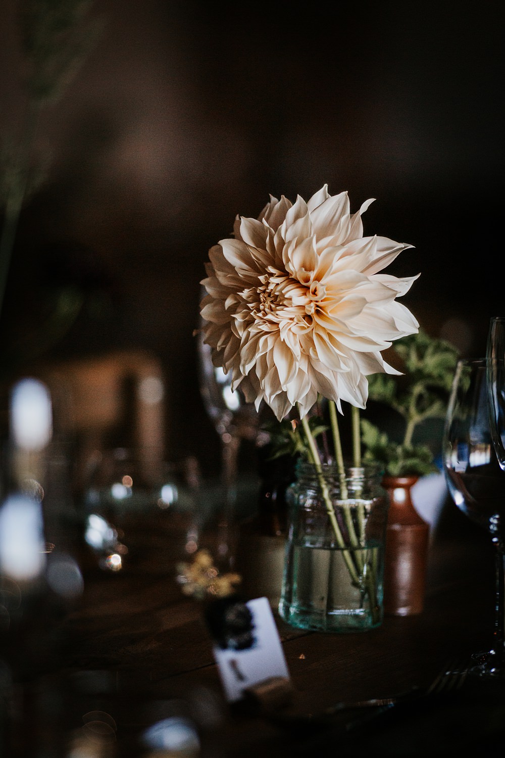 Chidham Barn Wedding Lucy Davis Photography Rustic Wooden Table Flowers Bottles Centrepiece