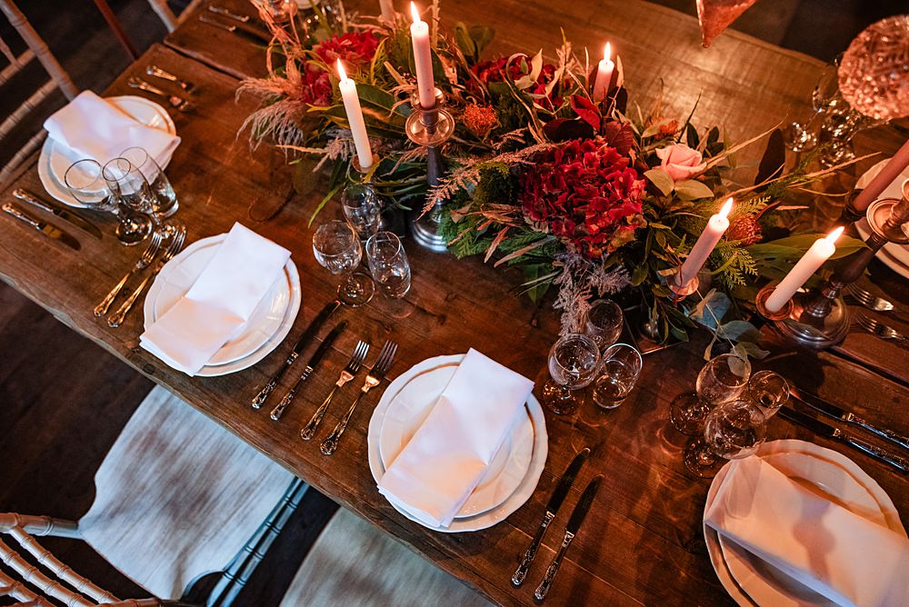 Vintage Winter Wonderland Wedding Ideas Natalia Case Photography Wooden Table Christmas Greenery Baubles Decor Candles Flowers