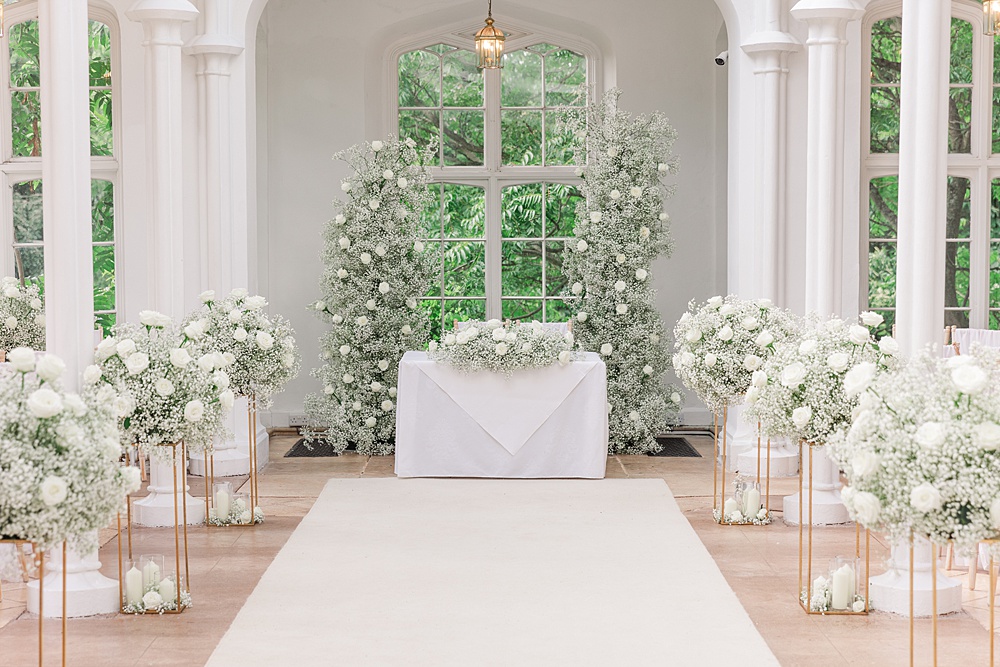 St Audries Park Wedding James and Kerrie Photography Ceremony Flowers Aisle Gypsophila Rose White Pillars Backdrop