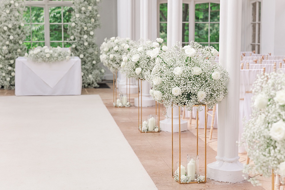 St Audries Park Wedding James and Kerrie Photography Ceremony Flowers Aisle Gypsophila Rose White Pillars Backdrop