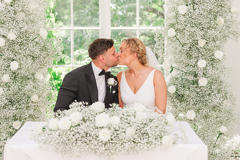 St Audries Park Wedding James and Kerrie Photography Ceremony Flowers Aisle Gypsophila Rose White Pillars Backdrop