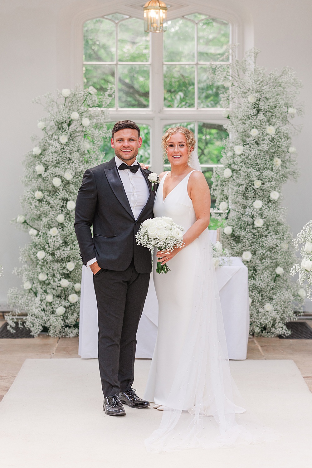 St Audries Park Wedding James and Kerrie Photography Ceremony Flowers Aisle Gypsophila Rose White Pillars Backdrop