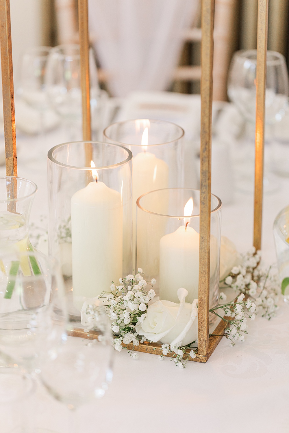 St Audries Park Wedding James and Kerrie Photography Pillar Candles White Rose Gypsophila Centrepiece