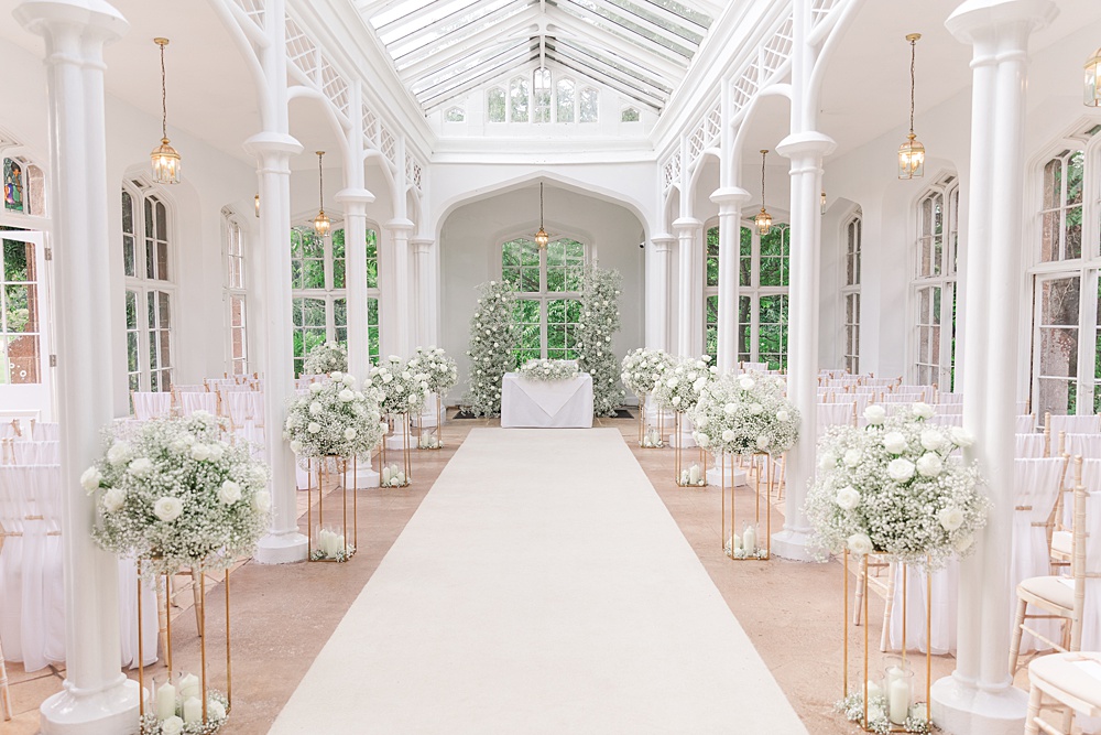 St Audries Park Wedding James and Kerrie Photography Ceremony Flowers Aisle Gypsophila Rose White Pillars Backdrop