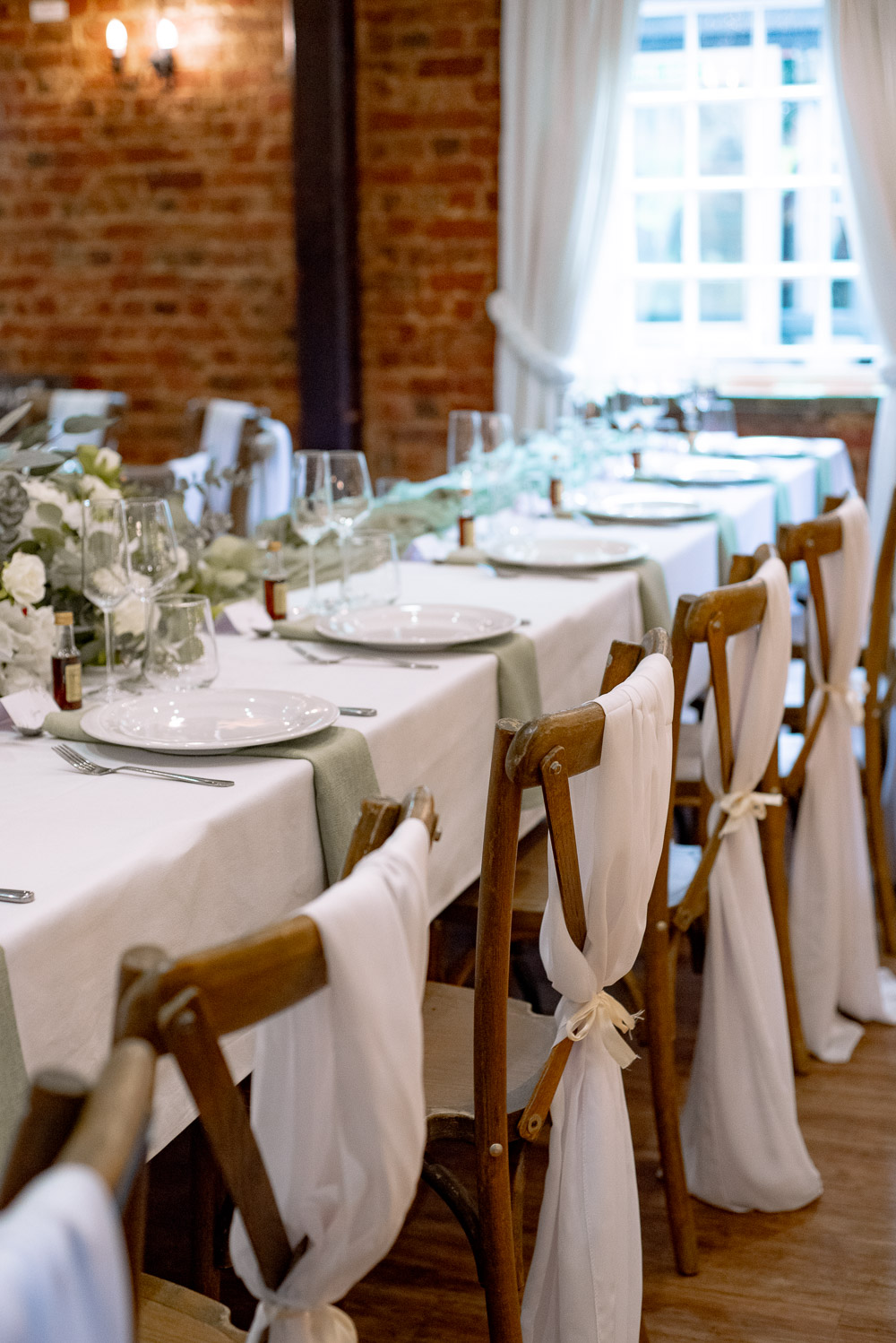 The Old Mill Aldermaston Wedding Nicola Belson Photography Long Table Fabric Chair Backs Green Linen White Roses Greenery Decor