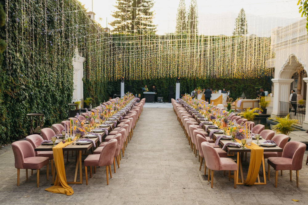 Antigua Guatemala Destination Wedding Daniel Lopez Perez Wedding Photography Fairy Lights Centrepiece Flowers Yellow Lilac decor Candles Table