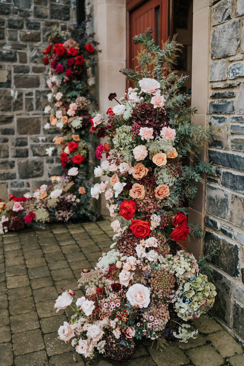 Tullyglass Hotel Wedding Sheena T Photography Flowers Entrance Pillars Doorway Red Pink Orange