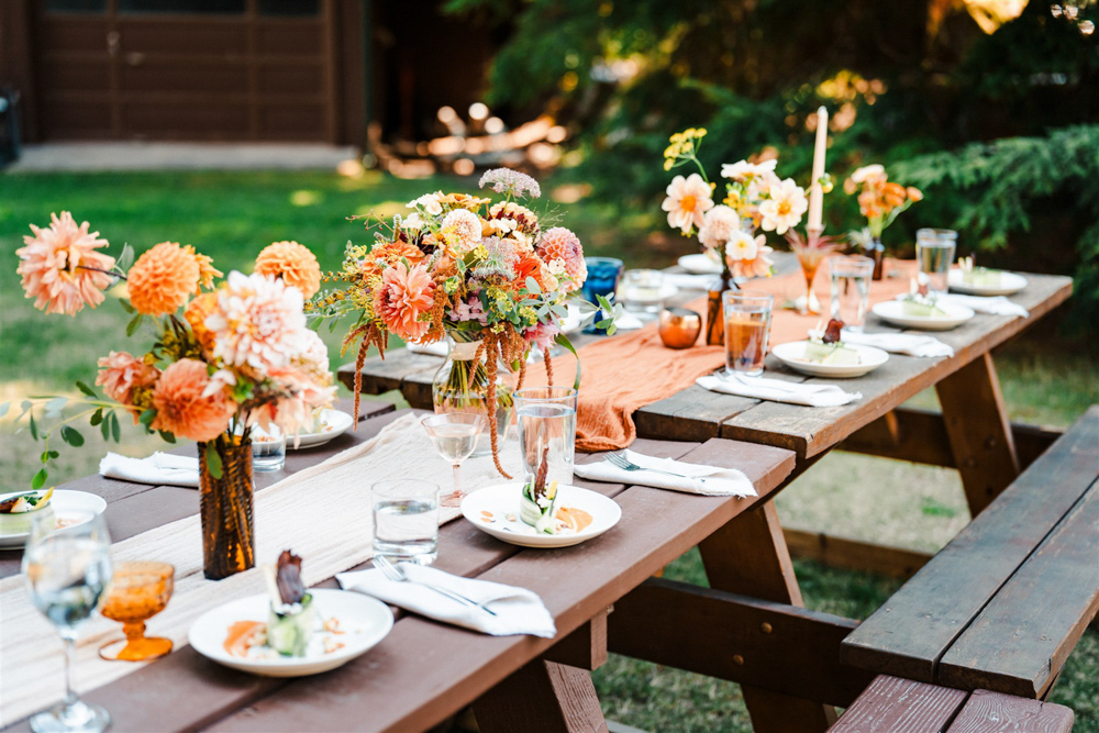 North Cascades National Park Elopement The Foxes Photography Picnic Table Bench Decor Orange Runner Dahlia Flowers Bottles