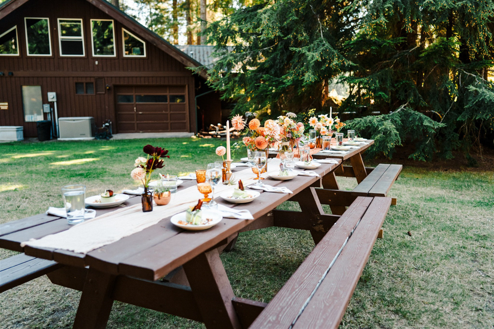 North Cascades National Park Elopement The Foxes Photography Picnic Table Bench Decor Orange Runner Dahlia Flowers Bottles
